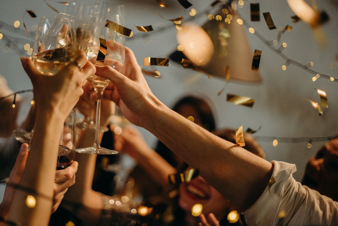 Guests raising glasses in a toast at a catered milestone birthday celebration