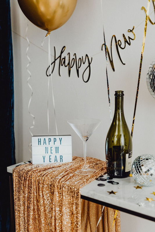 A festive New Year catering table set with champagne and celebration decorations