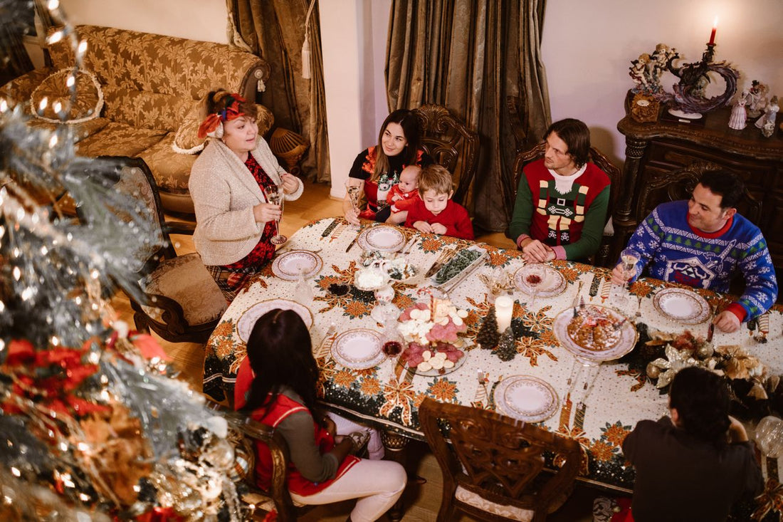 A family gathered around a Christmas dinner table with holiday decor